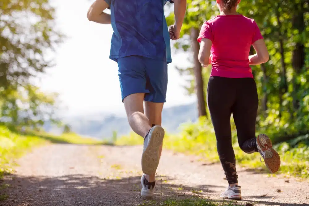 man and woman jogging outside